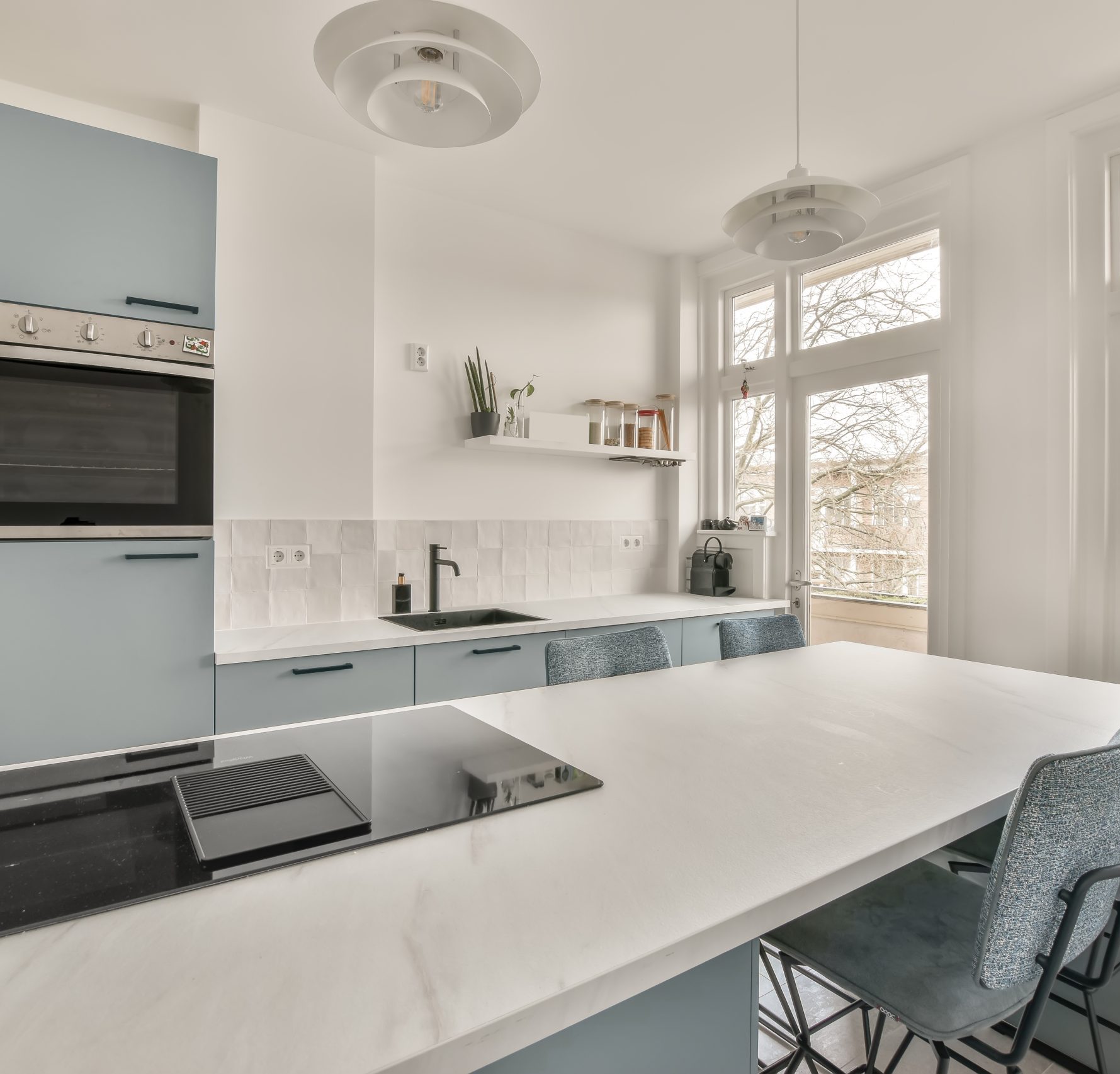 Small kitchen with dining area and marble countertops on tiled floor